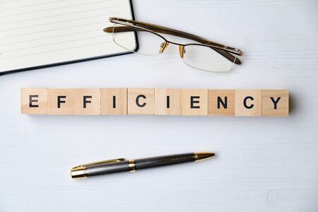 Modern business buzzword - efficiency. Top view on wooden table with blocks. Top view. Close up.の写真素材