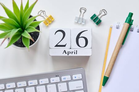 Date on white wooden cubes - the twenty sixth, 26, April 01 on a white table. Top view. Close up.の写真素材