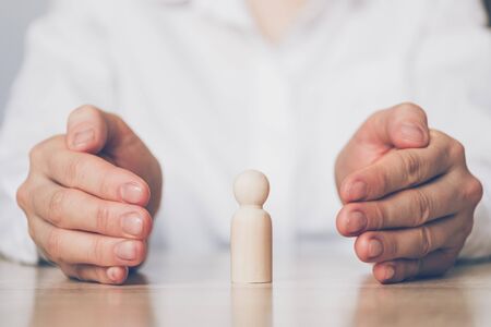 Personal and personal insurance concept - an object abstract between the palms. Close up.の写真素材