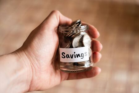 Money savings concept - glass jar with coins. Close up.の写真素材