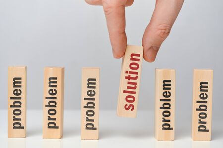 Problem solution concept - hand holds wooden block with the inscription. Close up.の写真素材