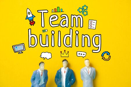 Team building concept - abstract figures of employees on a yellow background with text and icons. Close up.の写真素材