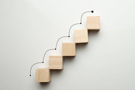 Growth concept by career ladder. Wooden cubes to the top. Close up.の写真素材