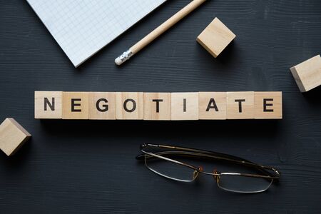 Modern business buzzword - negotiate. Top view on wooden table with blocks. Top view. Close up.の写真素材