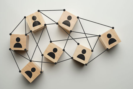 Teamwork concept - abstract portraits of people on wooden blocks with ties. Close up.