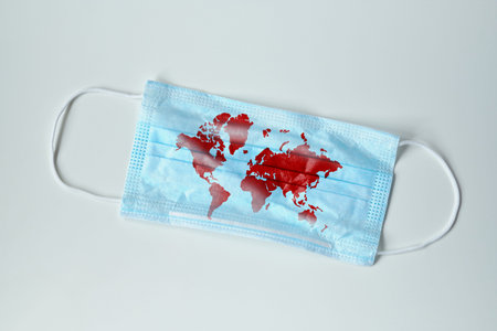 Concept of protecting the world from a virus covid-19 icons on a medical mask. Close up.