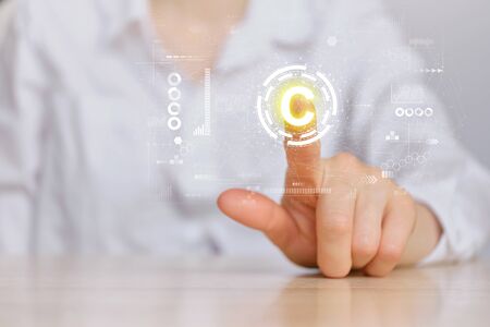 Copyright concept and hand pointing to an abstract sign with graphics. Close up.の写真素材