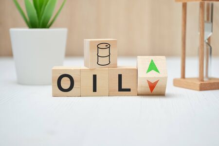 The concept of changing the cost of oil on wooden cubes. Close up.の写真素材
