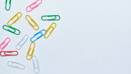 Multi-colored paper clips on a white background. Top view. Close up. Copy space.の写真素材