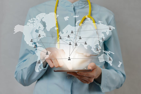 The doctor abstractly clicks on a tablet with an abstract world map and statistics on infected people. Close up.の写真素材