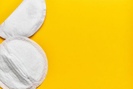 Female bra pads on a yellow background with copy space. Top view.の写真素材