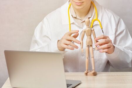 A male doctor teaches a person through an online video conferenceの写真素材