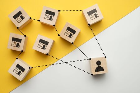 Shop owner concept with icons on wooden cubesの写真素材