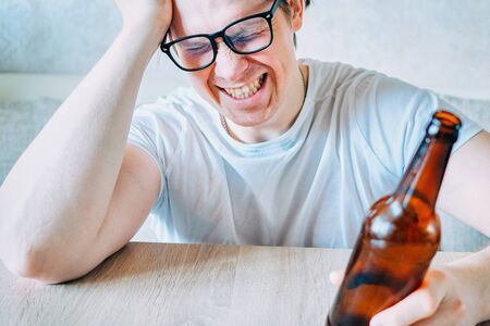 A drunk man is experiencing a deep personal crisisの写真素材