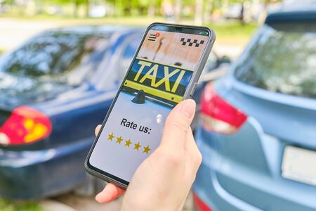 Concept ratings of 5 stars taxi in the application on a smartphoneの写真素材