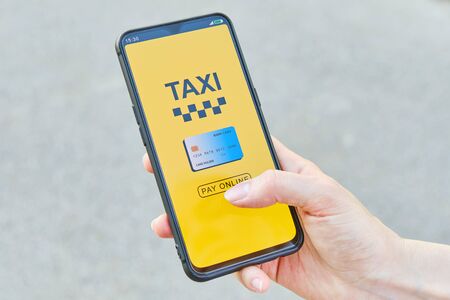 Concept of paying online by credit card taxi in the application on a smartphoneの写真素材