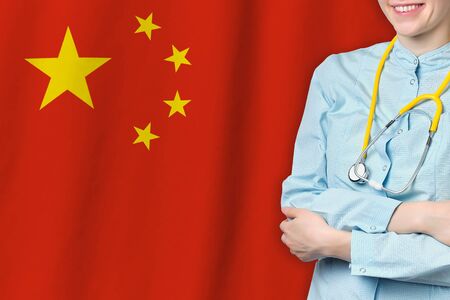 People Republic of China healthcare concept with doctor man on flag background. Medical insurance, work or study in the countryの写真素材