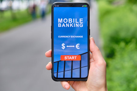 Mobile banking interface with currency exchange function in smartphone and holding by hand