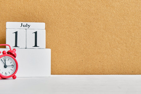 11th july - eleventh day month calendar concept on wooden blocks with copy space