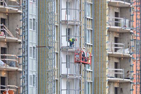Workers build a balcony in a new modern residential building.の写真素材