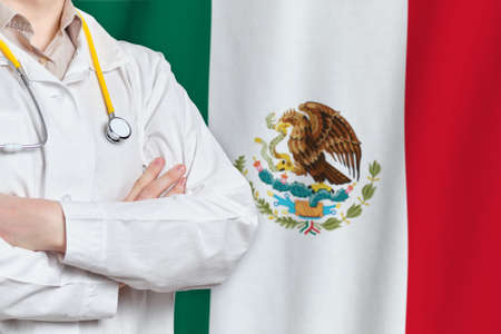United Mexican States healthcare concept with doctor on flag background. Medical insurance, work or study in the countryの写真素材