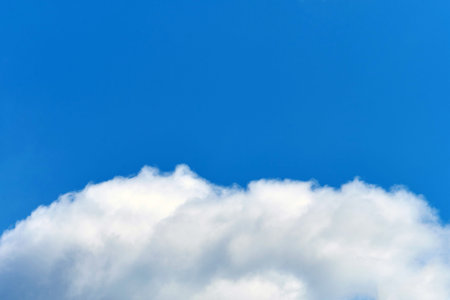 A white cloud in the blue sky with a copy space.