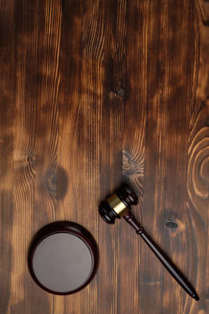 Judge hammer on brown wooden background with copy of space.の写真素材