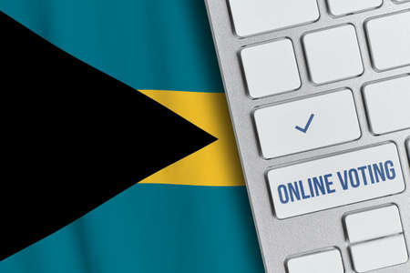 Online voting concept in Commonwealth of The Bahamas. Keyboard near country flagの写真素材