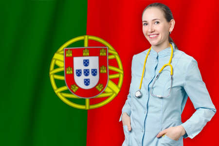 Portuguese Republic healthcare concept with doctor on Portugal flag background. Medical insurance, work or study in the countryの写真素材