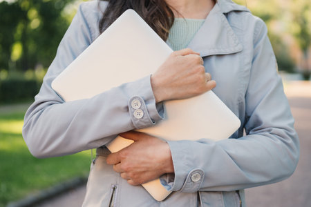 Caucasian girl holding a laptop in her hands.の写真素材