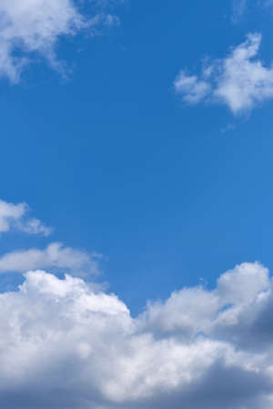 Blue and sunny sky with white clouds in the summerの写真素材