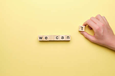 We can as a motivating concept on wooden blocks with a handの写真素材