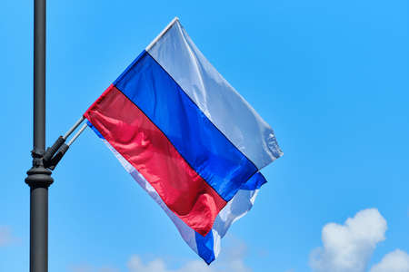 The Russian flag develops from the wind against the background of the sky.の写真素材