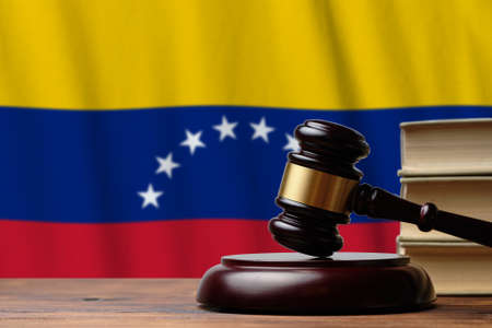 Justice and court concept in Bolivarian Republic of Venezuela. Judge hammer on a flag background.の写真素材