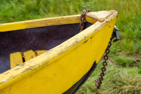 Front of wooden boat on green grass background.の写真素材