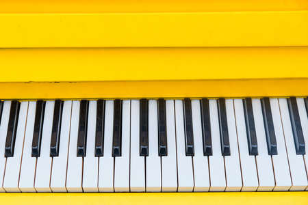 Panel with yellow piano keys with top view.の写真素材