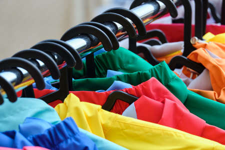 Sale of autumn and spring clothes on the hanger of the fair.の写真素材