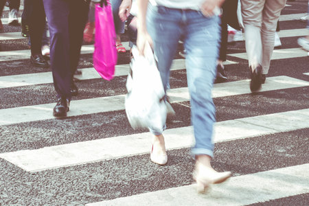 The concept of urban fuss with people crossing the road.