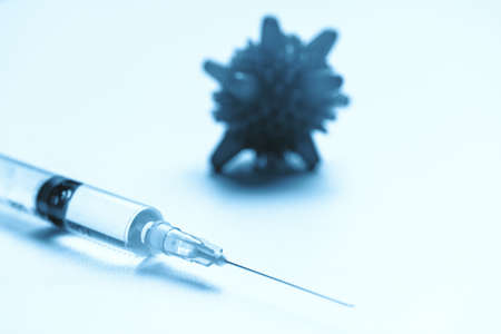 Flu shot concept with abstract germ and syringe.の写真素材