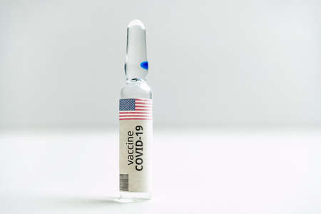 American USA developments of a coronavirus covid-19 vaccine in a glass ampoule.の写真素材