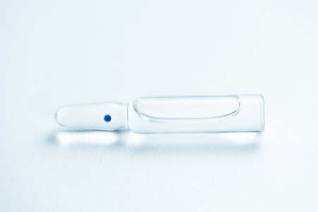 Glass ampoule with medicine on the table.