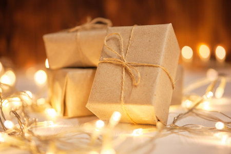 Christmas and new year gifts concept on wooden background with garlands.の写真素材