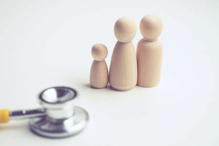 Family examination concept by doctor with stethoscope and abstract family.の写真素材