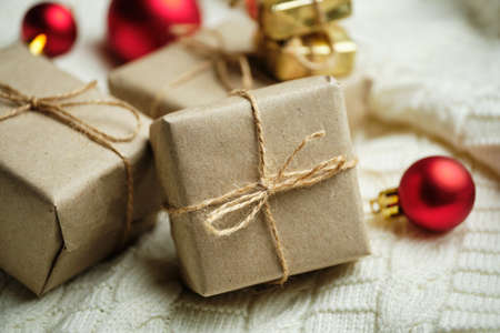 Gifts in craft packaging among New Year toys.の写真素材