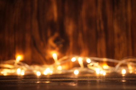 Wooden new year and christmas blurry background with garland.