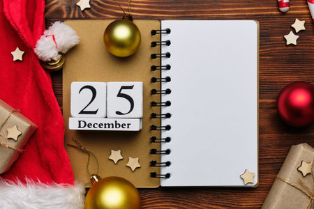 December twenty-fifth in New Year decor and copy space with notepad.