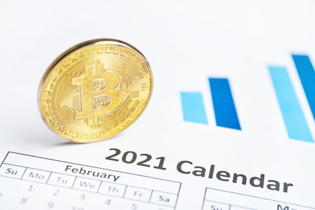 Bitcoin cryptocurrency concept in 2021 on the calendar close up.