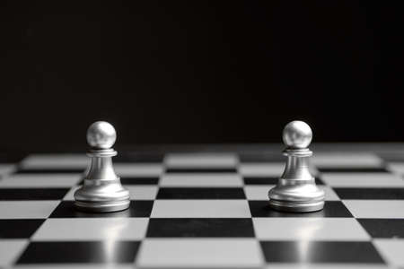 The concept of a confrontation of two pawns on a chessboard.の写真素材
