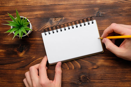 Person makes notes in a notebook