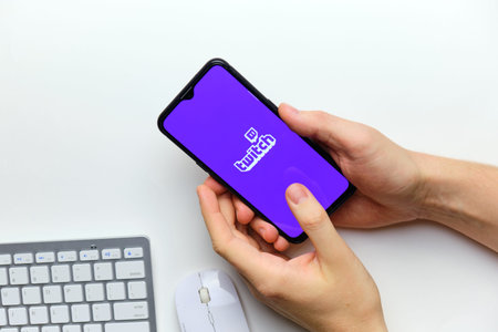 twitch streaming service on a mobile phone screen. russia, st.petersburg, 8 december 2020.のeditorial素材